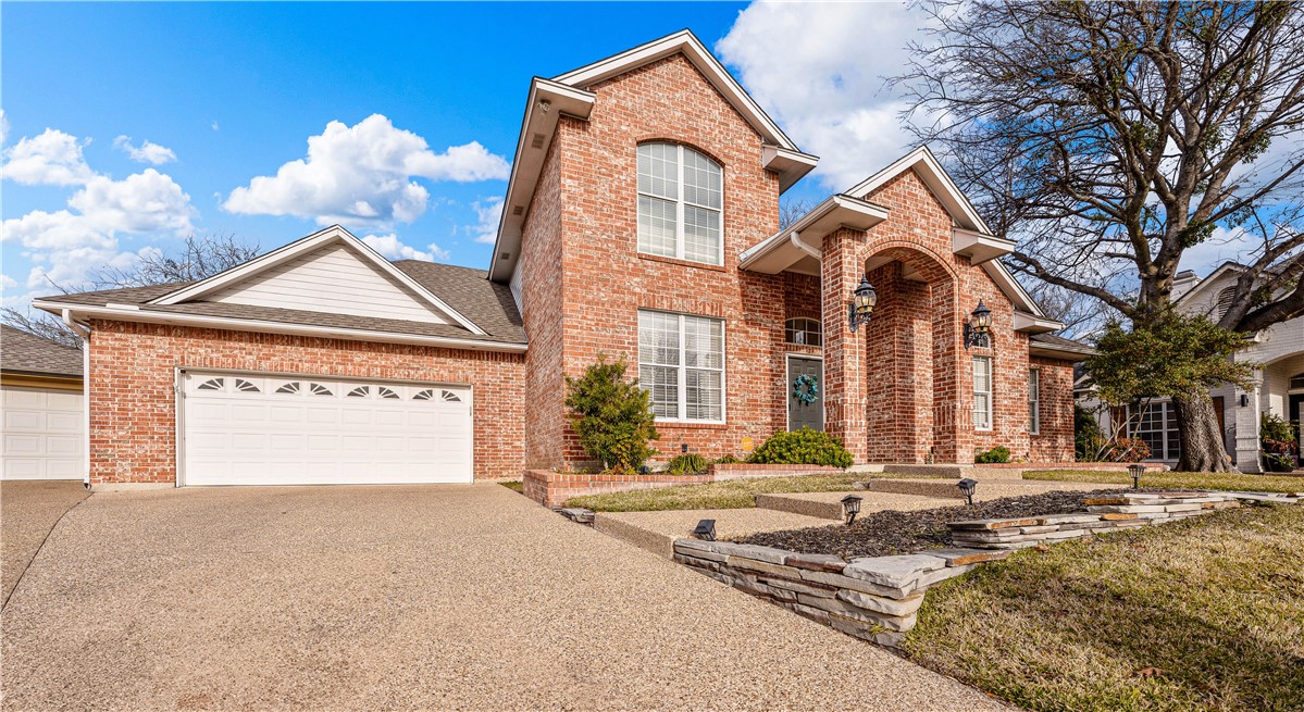 3313 Fox Hollow Circle Waco, TX 76708 - Photo 13 of 88 a front view of a house with a yard and garage