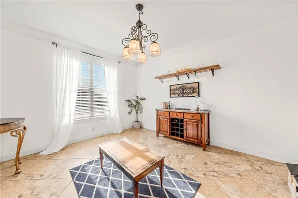 a kitchen with stainless steel appliances granite countertop a refrigerator a stove a sink dishwasher and a dining table with wooden floor