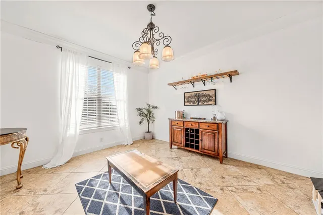 a kitchen with stainless steel appliances granite countertop a refrigerator a stove a sink dishwasher and a dining table with wooden floor