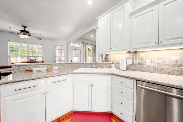 a white bath tub sitting in a bathroom next to a window