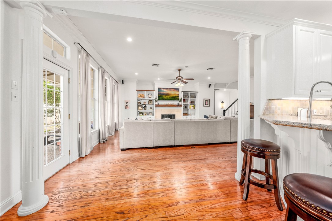 3313 Fox Hollow Circle Waco, TX 76708 - Photo 36 of 88 a large living room with stainless steel appliances kitchen island granite countertop furniture and a wooden floor