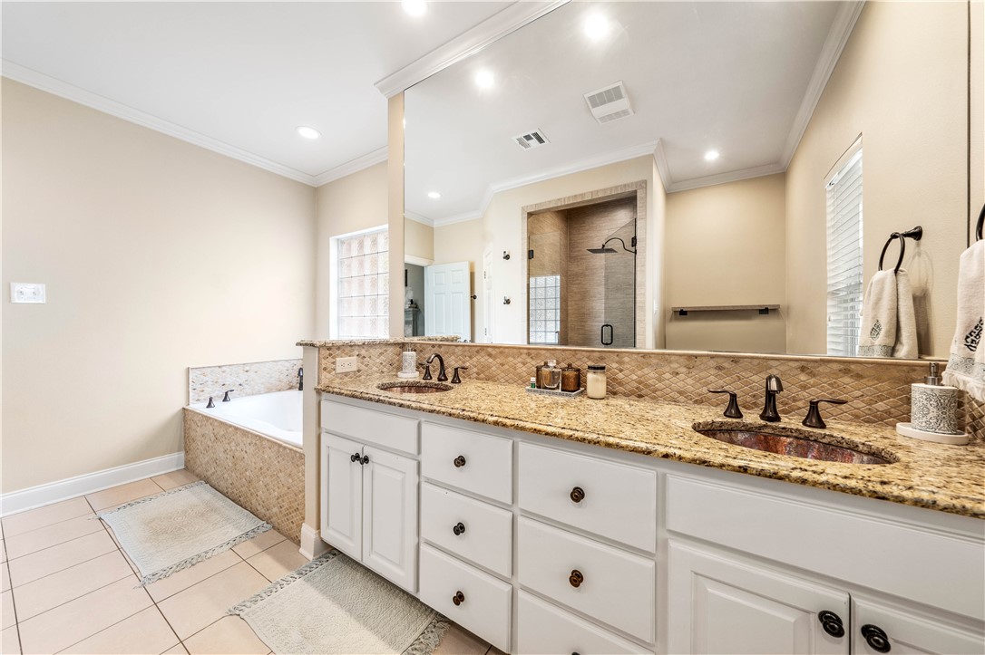 3313 Fox Hollow Circle Waco, TX 76708 - Photo 44 of 88 a bathroom with a granite countertop double vanity sink and a mirror