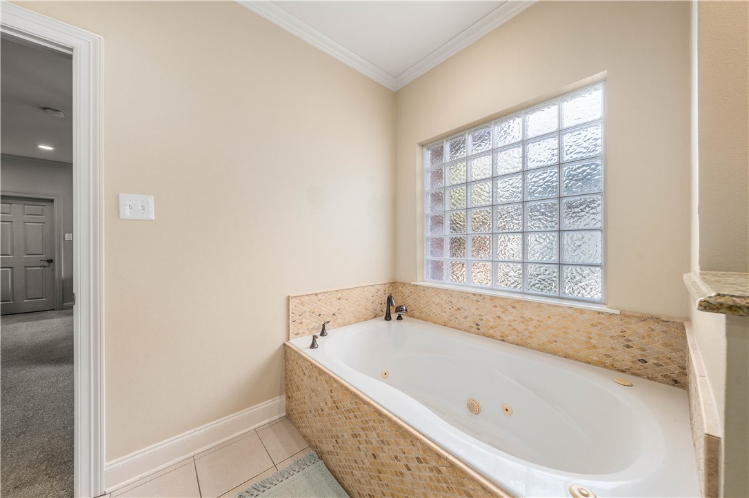 3313 Fox Hollow Circle Waco, TX 76708 - Photo 45 of 88 a white bath tub sitting in a bathroom next to a window