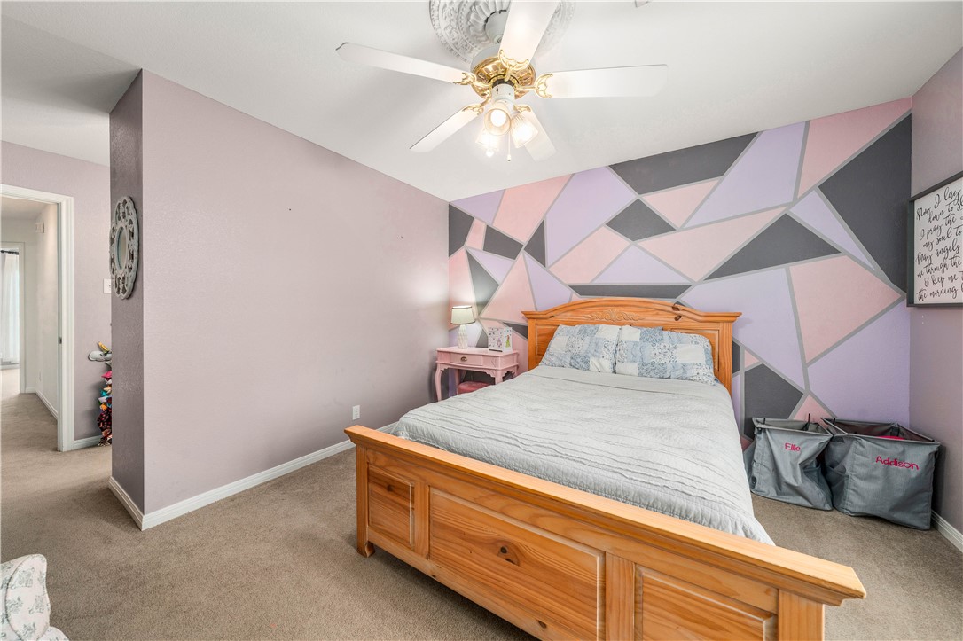 3313 Fox Hollow Circle Waco, TX 76708 - Photo 61 of 88 a bedroom with a bed and a chandelier