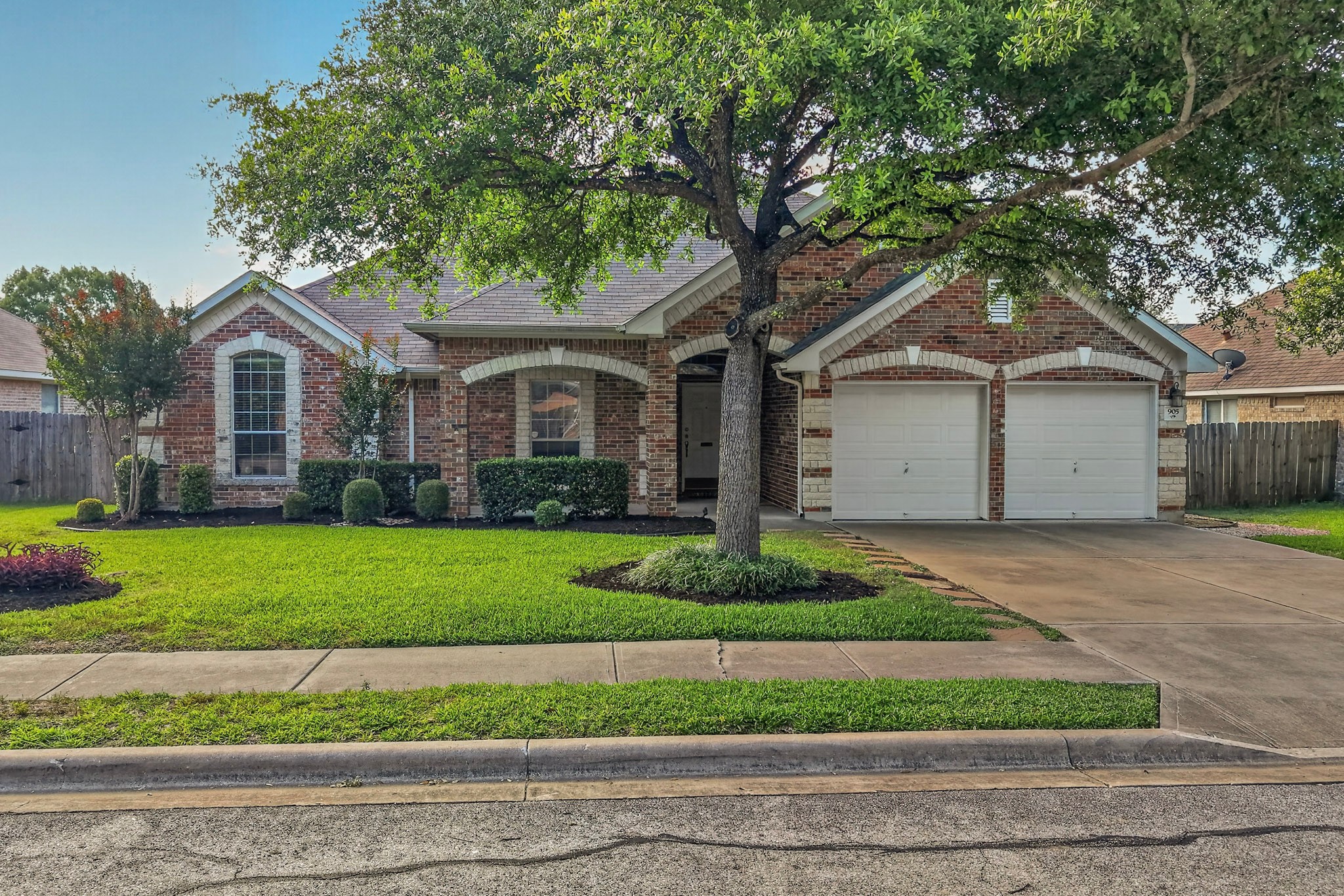 905 Victoria Ridge Drive Pflugerville, TX 78660 - Photo 2 of 32 A well-maintained brick facade home welcomes with a verdant lawn and mature shade trees.