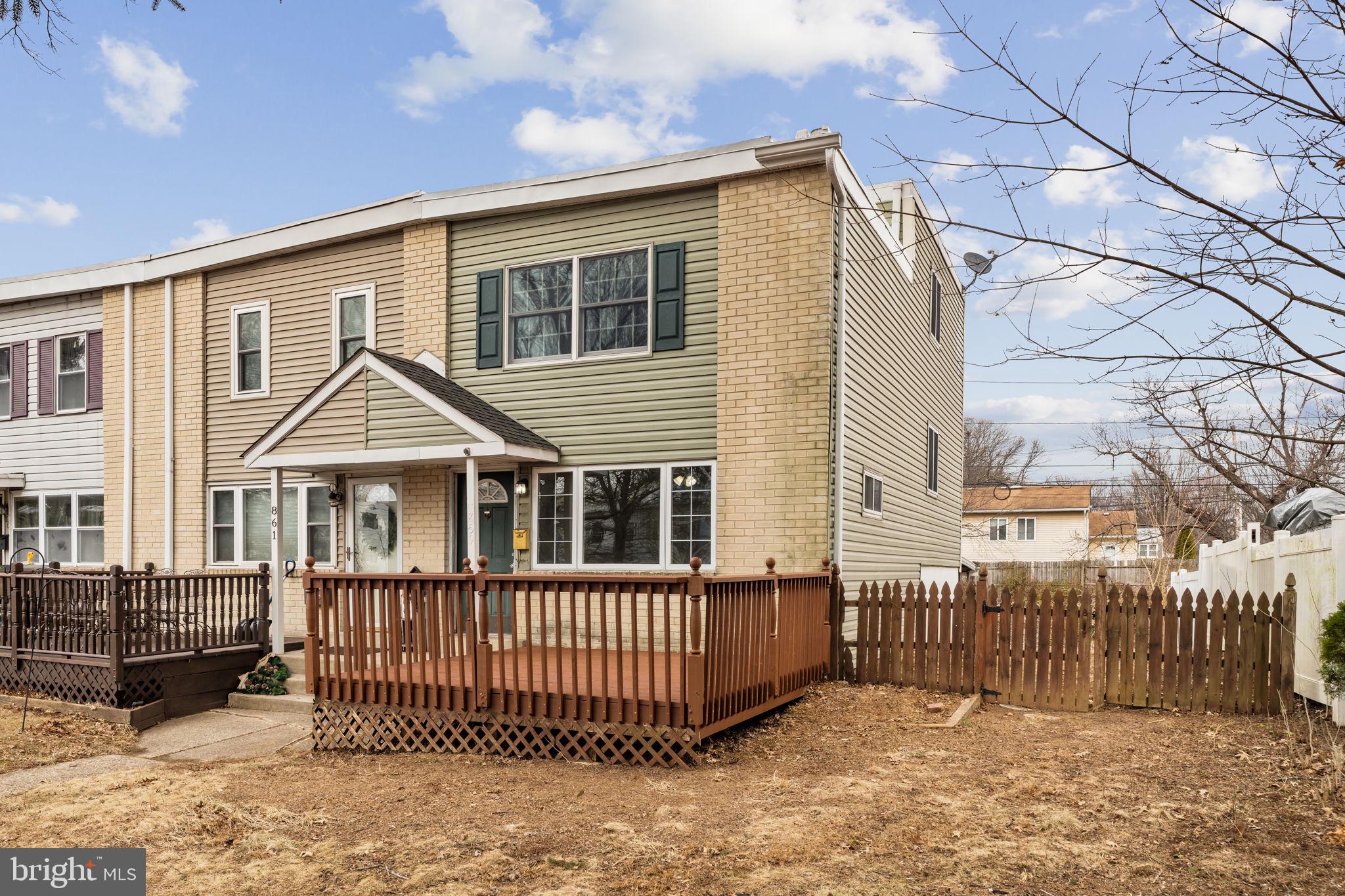 a view of a house with a wooden fence