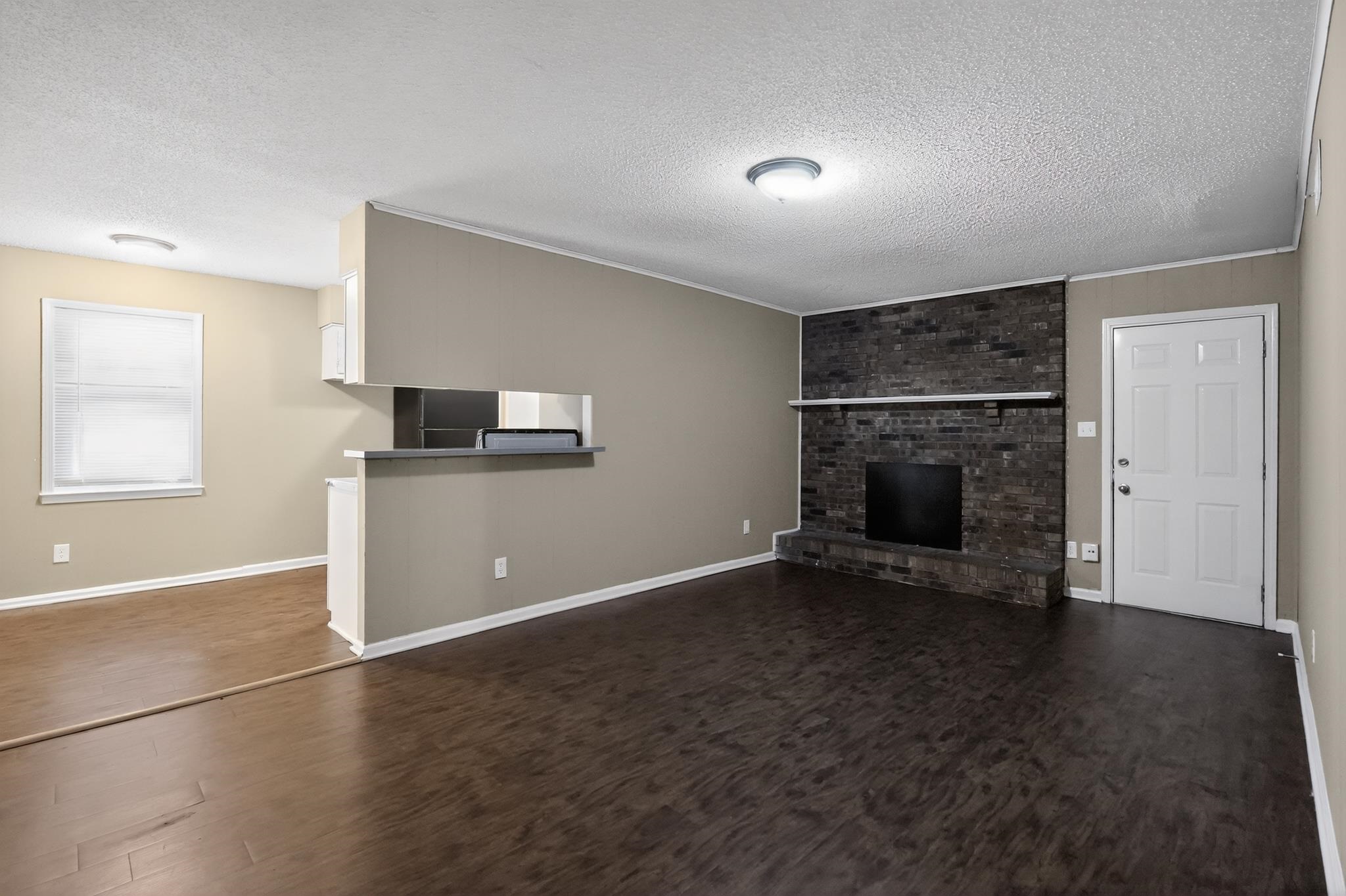 2015 East Holmes Road Memphis, TN 38116 - Photo 20 of 34 a view of empty room with a fireplace and wooden floor