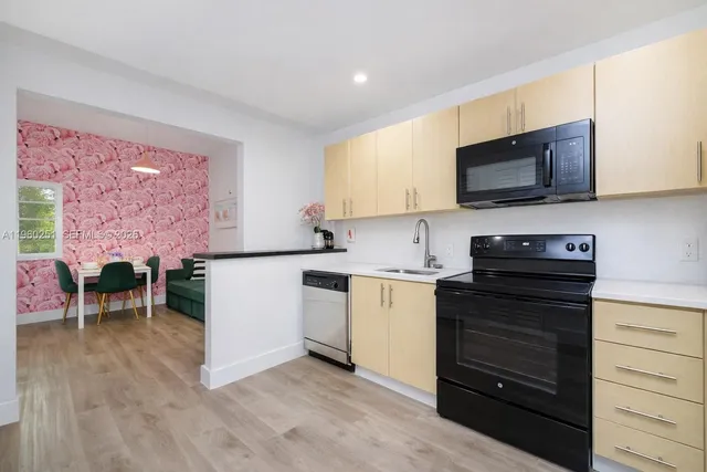 a kitchen with a sink stove and microwave
