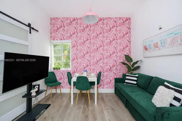 a living room with furniture wooden floor and a flat screen tv