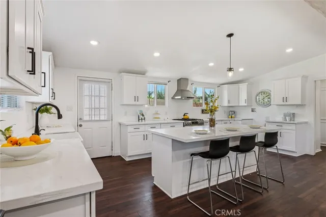 a kitchen with a sink and chairs