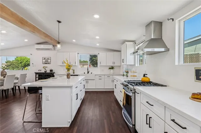 a kitchen with stainless steel appliances a sink stove and cabinets