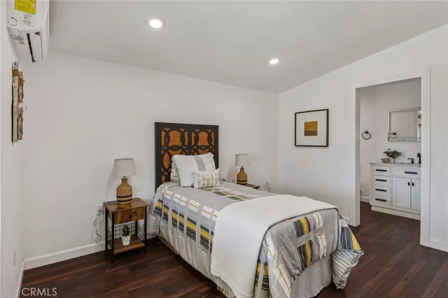 a bedroom with a bed and a view of bathroom