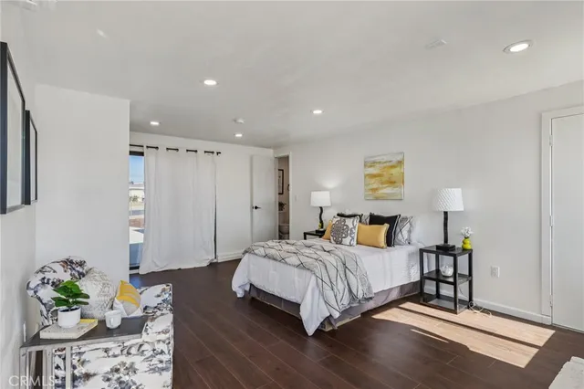 a bedroom with a bed table and a couch