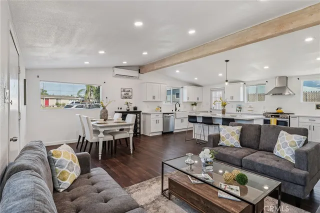 a living room kitchen with furniture and kitchen view