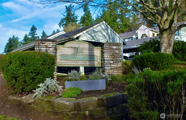 a front view of a house with a yard and potted plants
