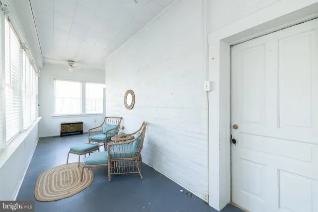 a living room with furniture a window and a table