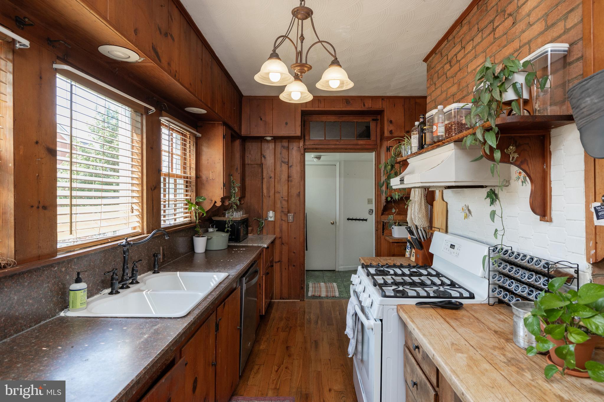 5378 Main Street Stephens City, VA 22655 - Photo 18 of 58 a kitchen with stainless steel appliances granite countertop a sink a stove and a wooden floors