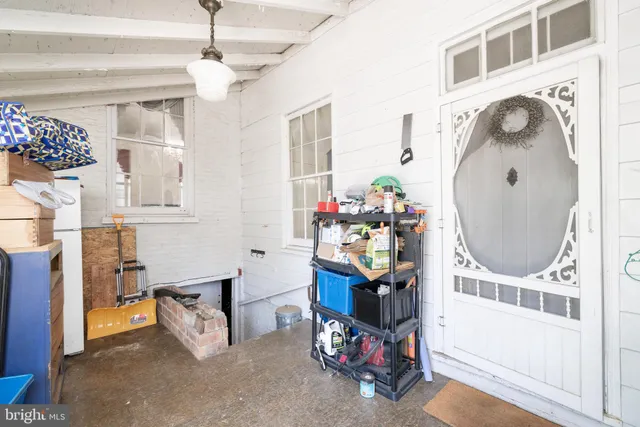 a living room with a fireplace furniture a rug and a chandelier