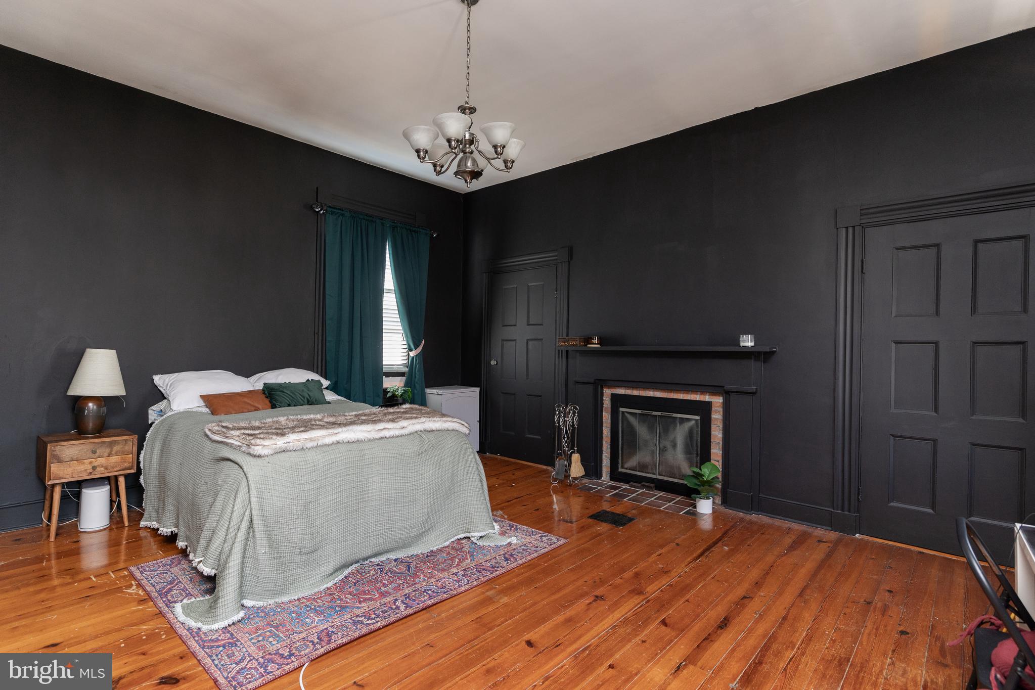 5378 Main Street Stephens City, VA 22655 - Photo 30 of 58 a living room with a fireplace furniture a rug and a chandelier