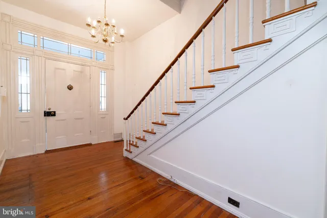 a view of entryway and hall with wooden floor