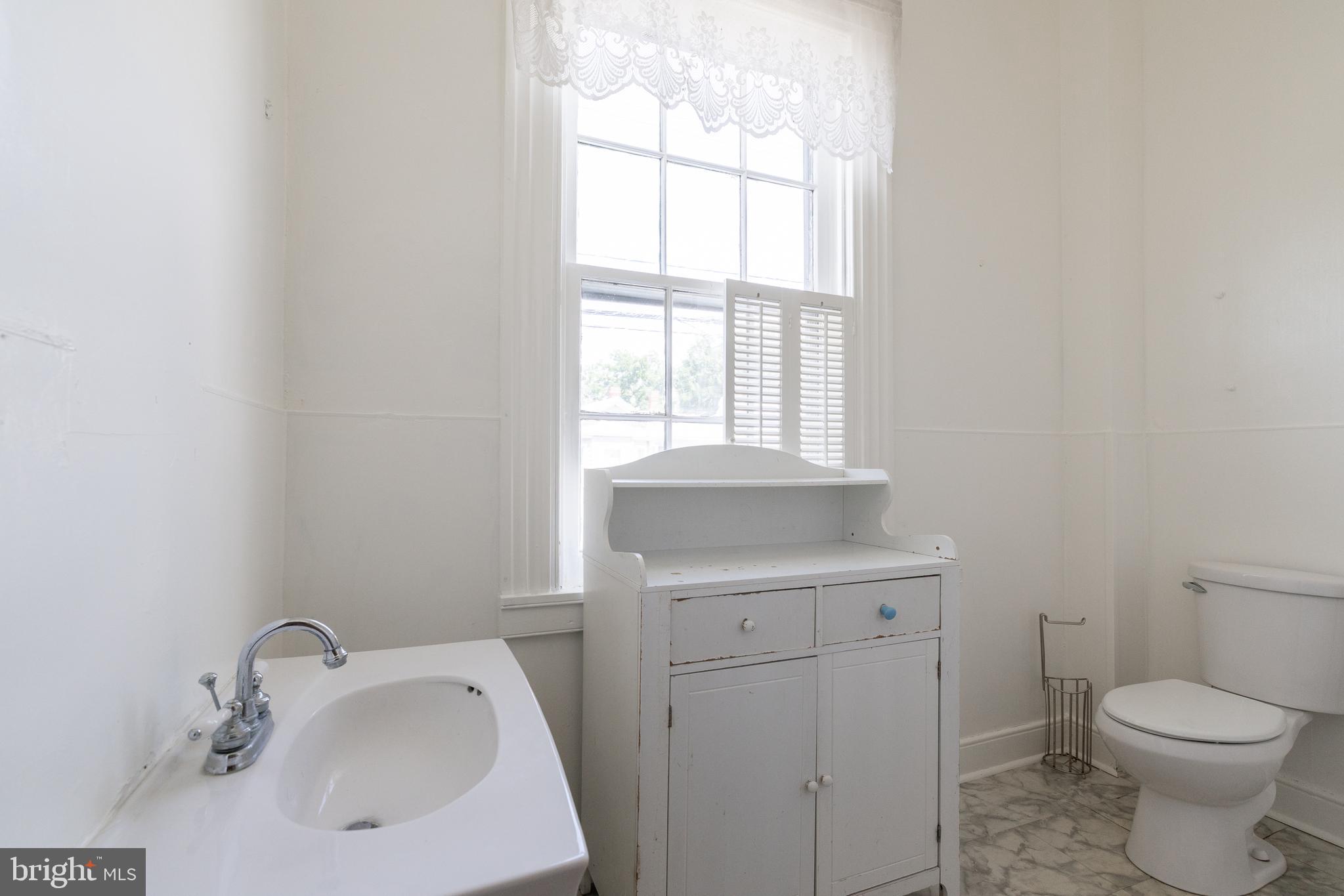 5378 Main Street Stephens City, VA 22655 - Photo 31 of 58 a bathroom with a sink toilet and window