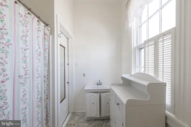 a bathroom with a shower curtain and a sink