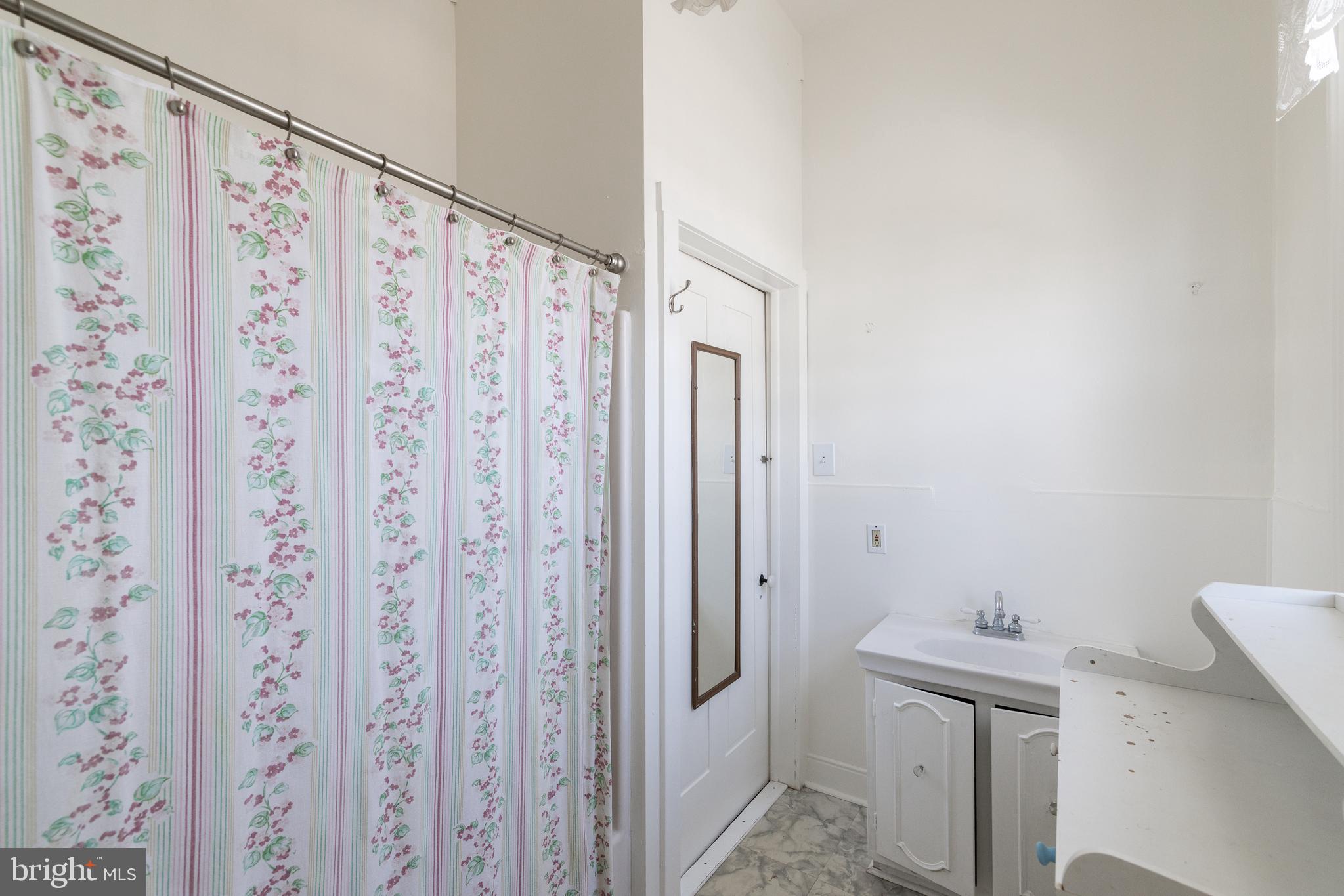 5378 Main Street Stephens City, VA 22655 - Photo 34 of 58 a bathroom with a shower curtain and a sink