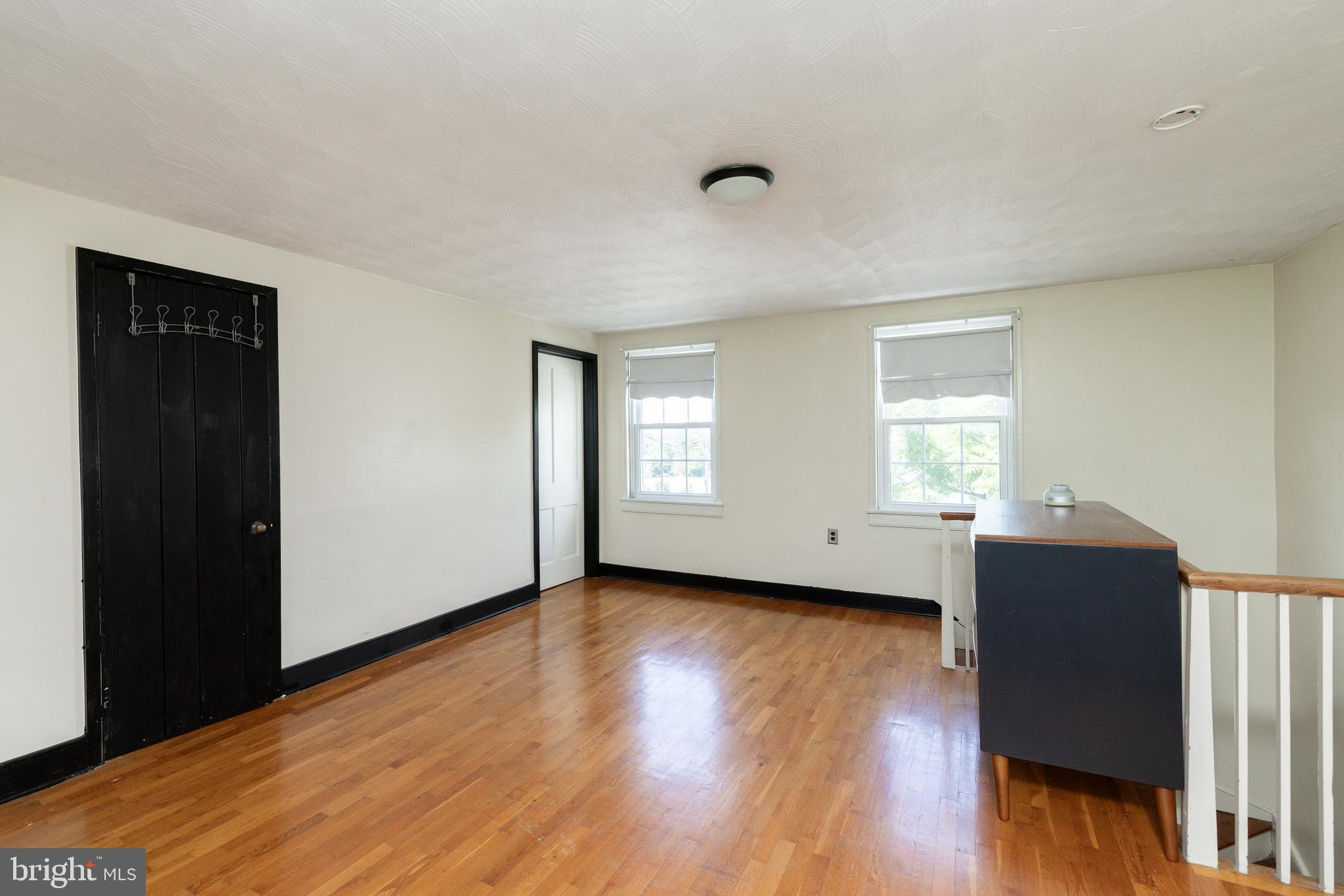 5378 Main Street Stephens City, VA 22655 - Photo 38 of 58 a view of an empty room with wooden floor and a window