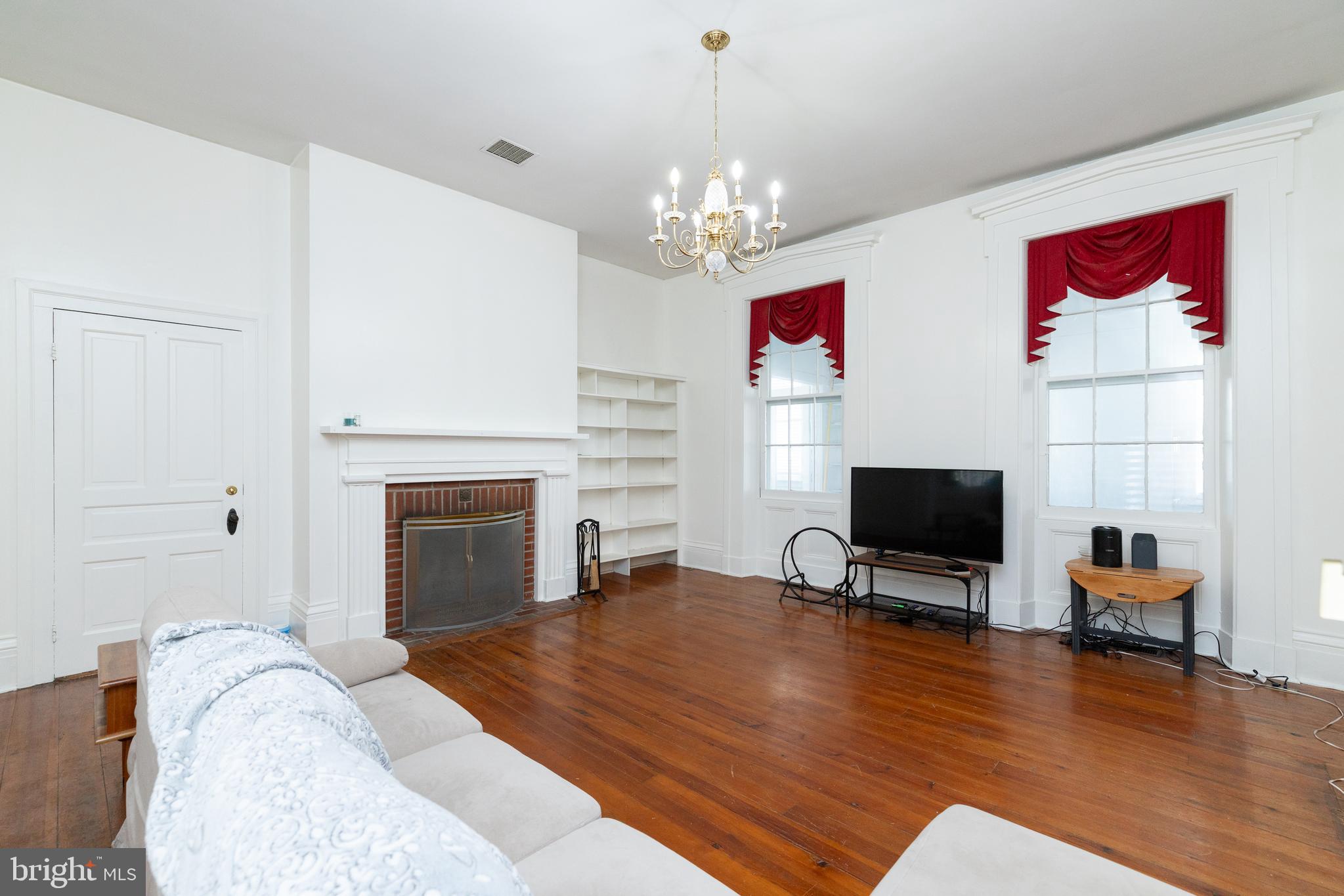 5378 Main Street Stephens City, VA 22655 - Photo 5 of 58 a living room with furniture a fireplace and a flat screen tv