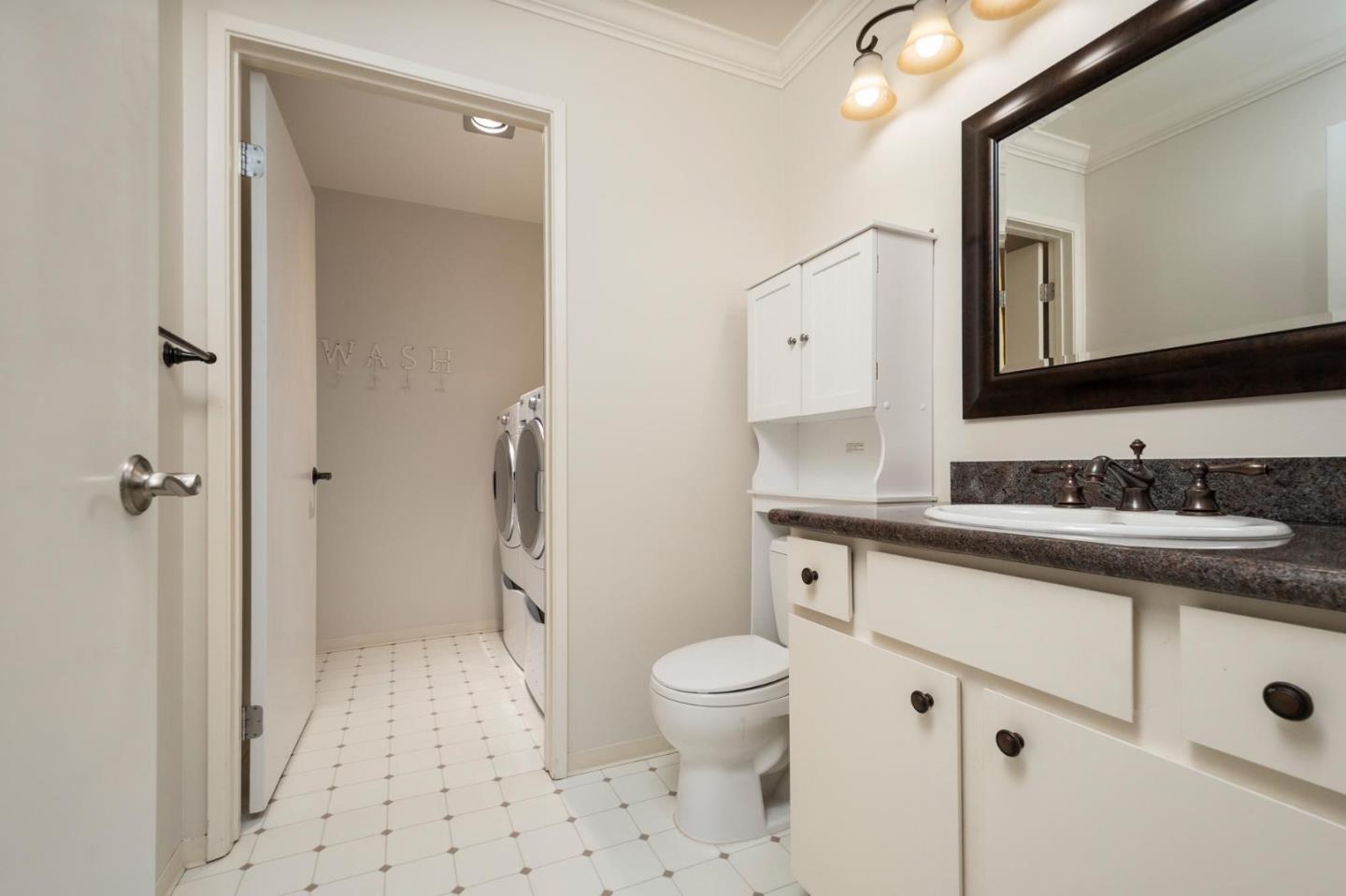 964 Shoreline Drive San Mateo, CA 94404 - Photo 14 of 19 a spacious bathroom with a granite countertop sink toilet mirror and a shower