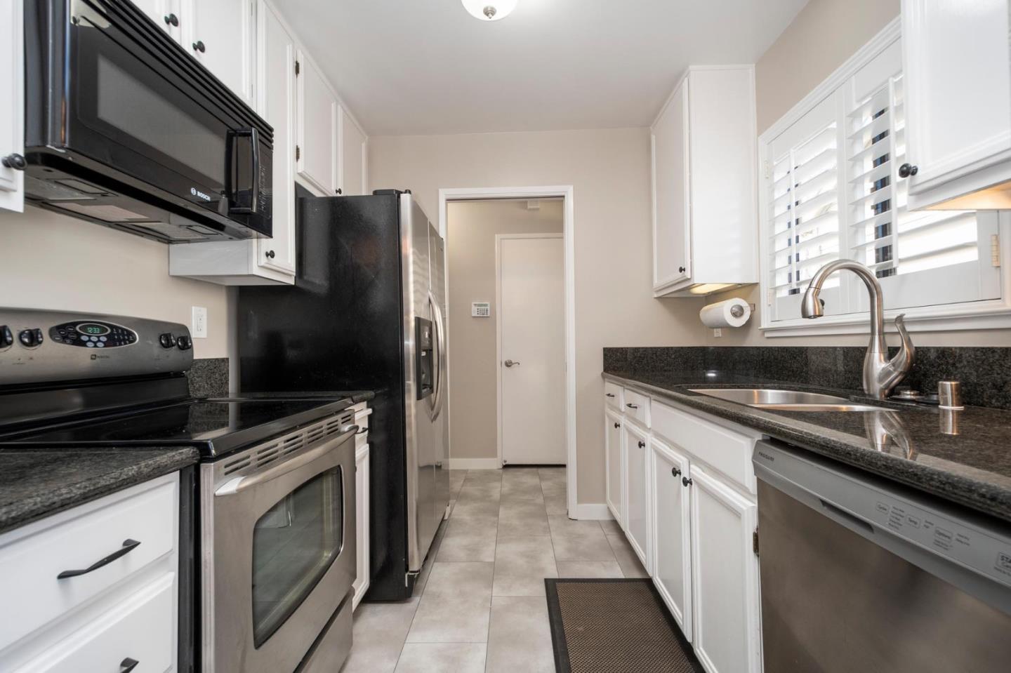 964 Shoreline Drive San Mateo, CA 94404 - Photo 7 of 19 a kitchen with stainless steel appliances granite countertop a sink stove and refrigerator
