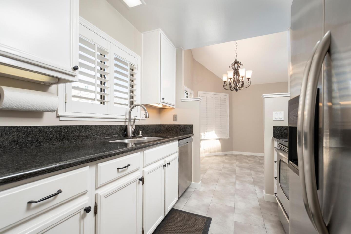 964 Shoreline Drive San Mateo, CA 94404 - Photo 8 of 19 a kitchen with stainless steel appliances granite countertop a sink and cabinets