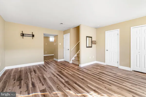 a view of a livingroom with wooden floor and staircase