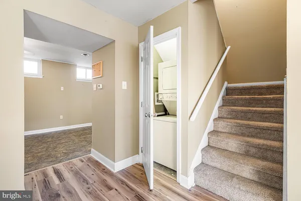 a view of entryway with wooden floor and stairs