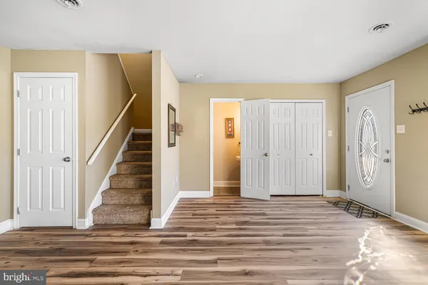 a view of a livingroom with wooden floor and stairs