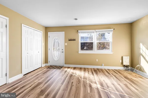 a view of a room with wooden floor and windows