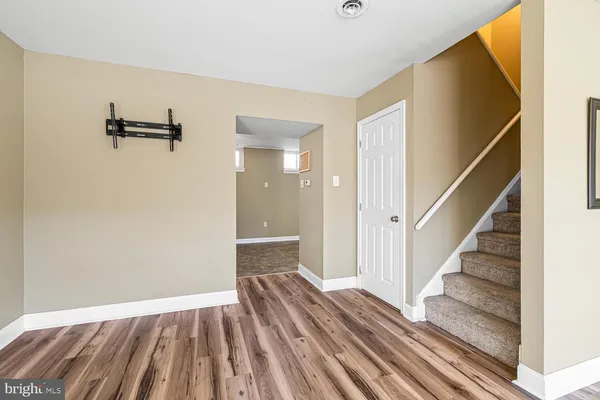 a view of a room with wooden floor and staircase