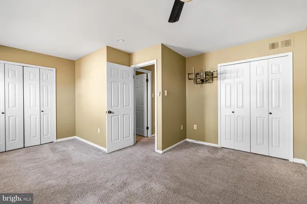 a view of an empty room with closet area