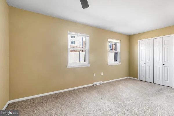a view of an empty room with windows