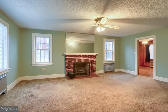 a view of an empty room with a fireplace