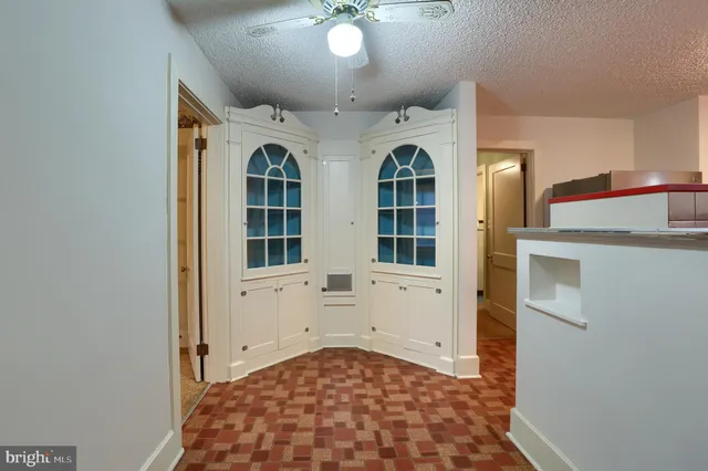 a view of a kitchen with wooden floor and a window