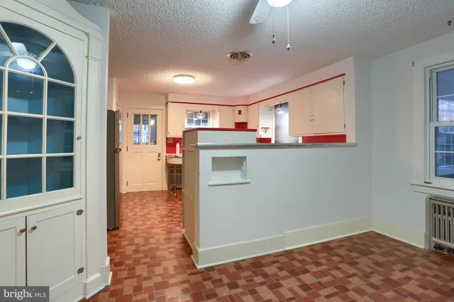 a kitchen with a sink and dishwasher with a vanity