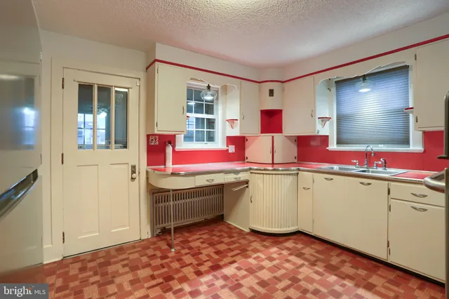 a kitchen with granite countertop a stove a sink and a microwave