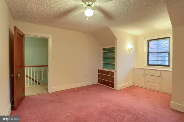 a view of a livingroom with a ceiling fan and window