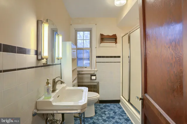 a front view of a house with a garden and yard