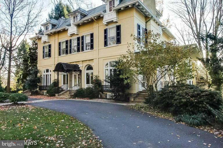 108 Ridgewood Road Baltimore, MD 21210 - Photo 2 of 30 a front view of a house with a yard and trees