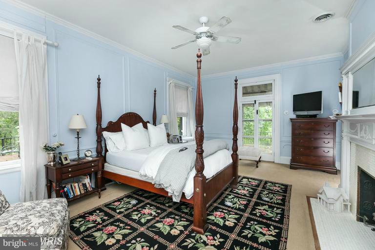 108 Ridgewood Road Baltimore, MD 21210 - Photo 14 of 30 a bed room with a bed and a chandelier