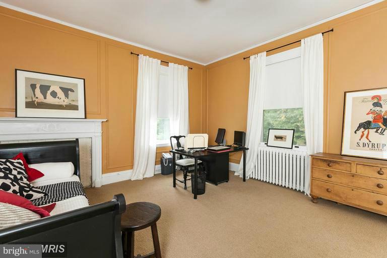 108 Ridgewood Road Baltimore, MD 21210 - Photo 19 of 30 a living room with furniture a fireplace and a window