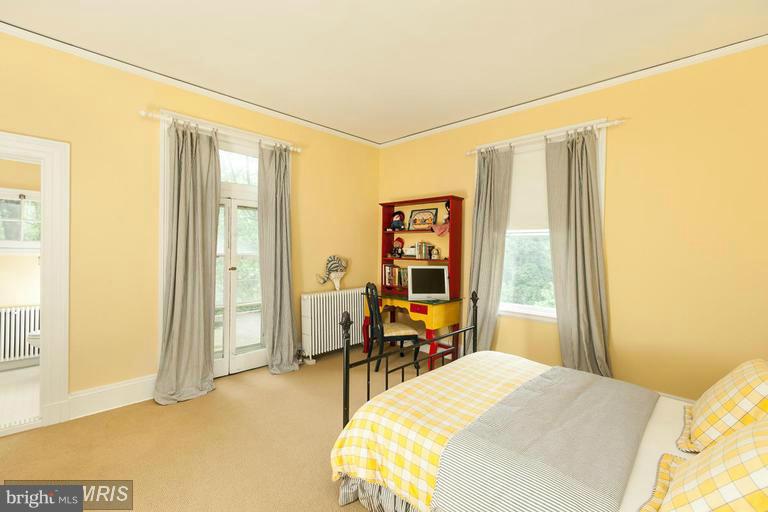 108 Ridgewood Road Baltimore, MD 21210 - Photo 21 of 30 a bedroom with a bed and large windows