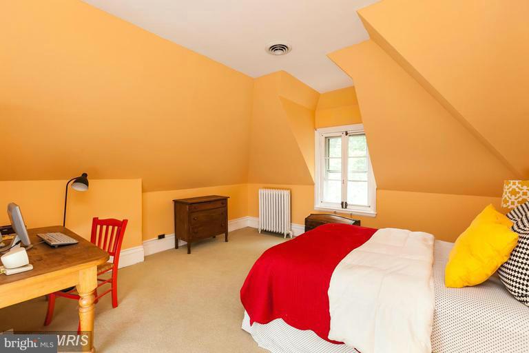 108 Ridgewood Road Baltimore, MD 21210 - Photo 22 of 30 a bed room with a bed and a chair